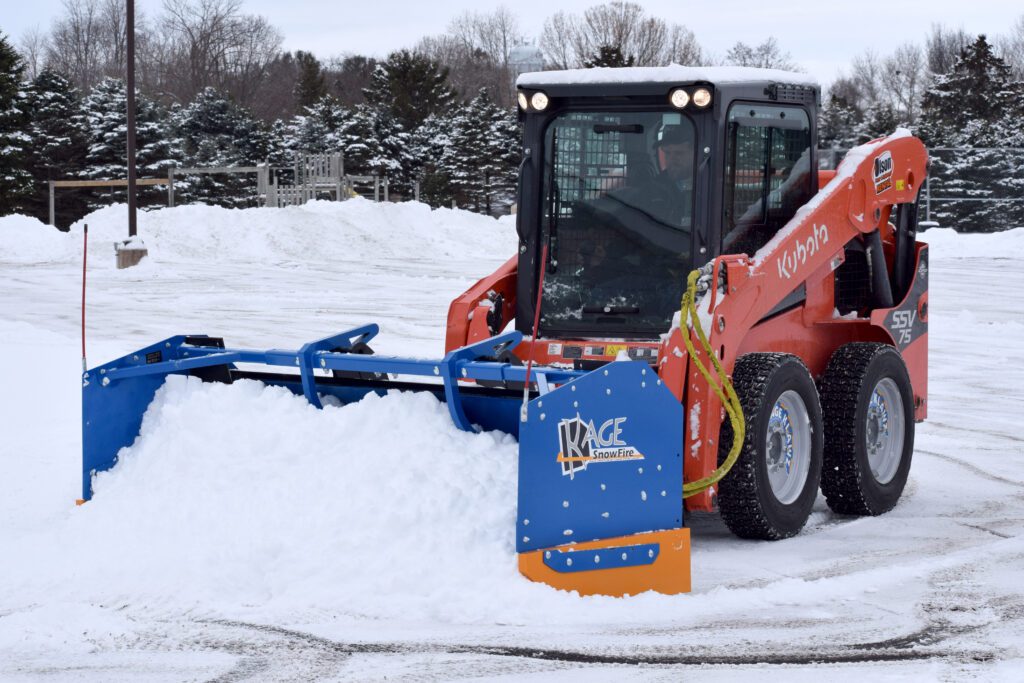 Kage Snowfire scraping snow with Kubota Skid Steer