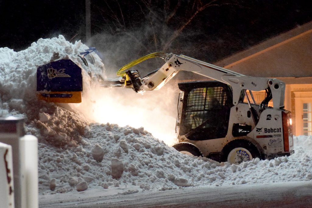 SnowFire plow stacking snow using Bobcat skid steer 