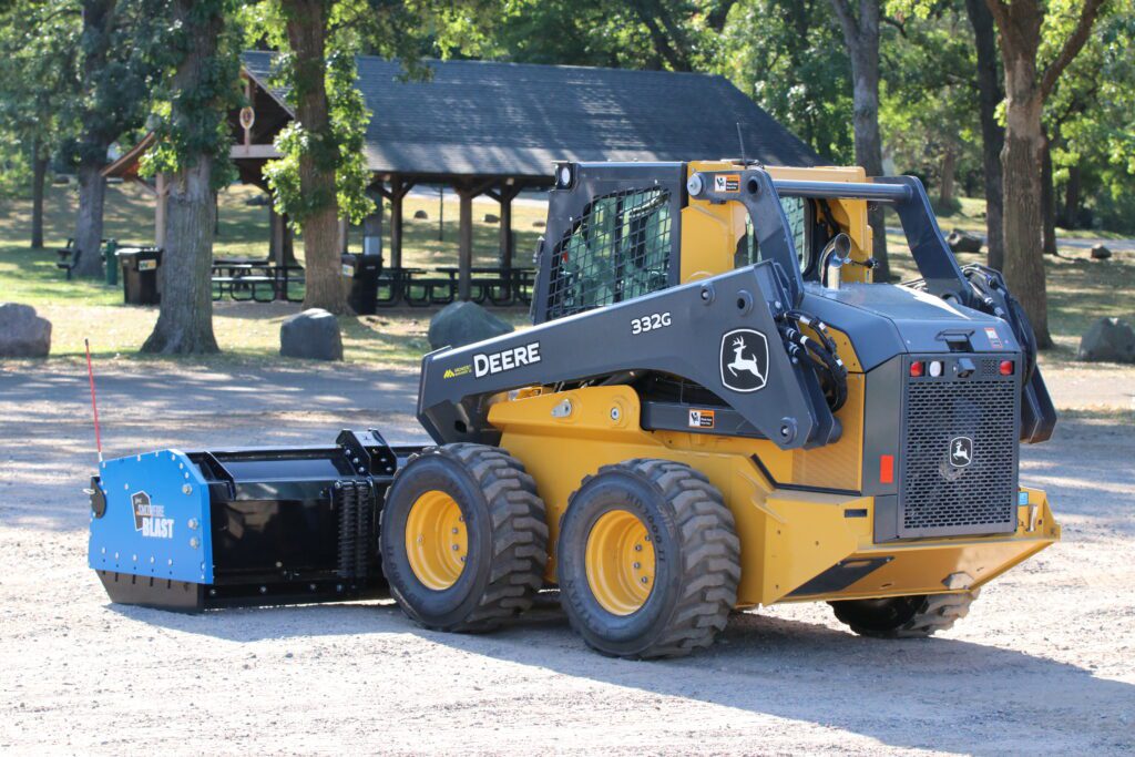 Blue Snow Pusher on John Deere Skid Steer