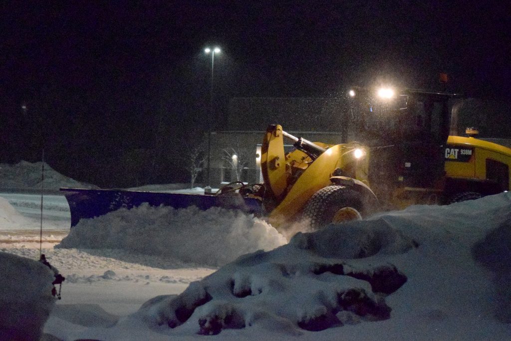 SnowDozer snow blade plowing on large wheel loader