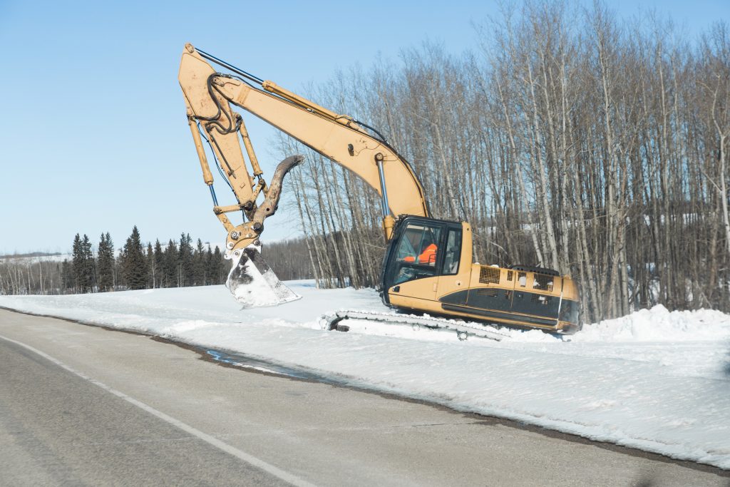 Excavator Digging Snow