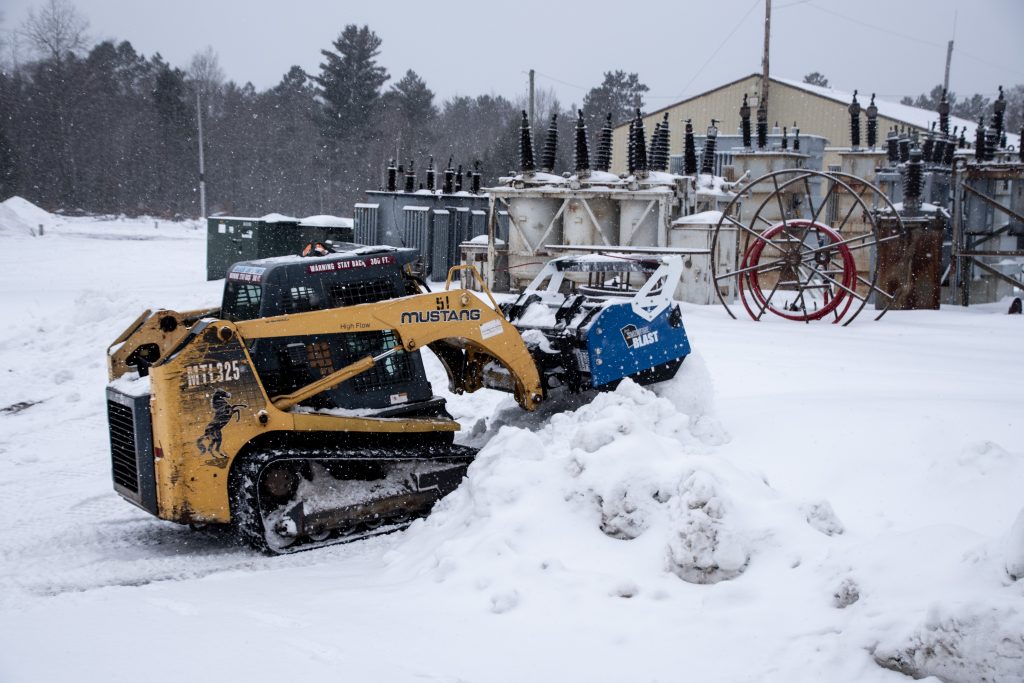 Pushing back snow banks with CTL for Electricity Provider